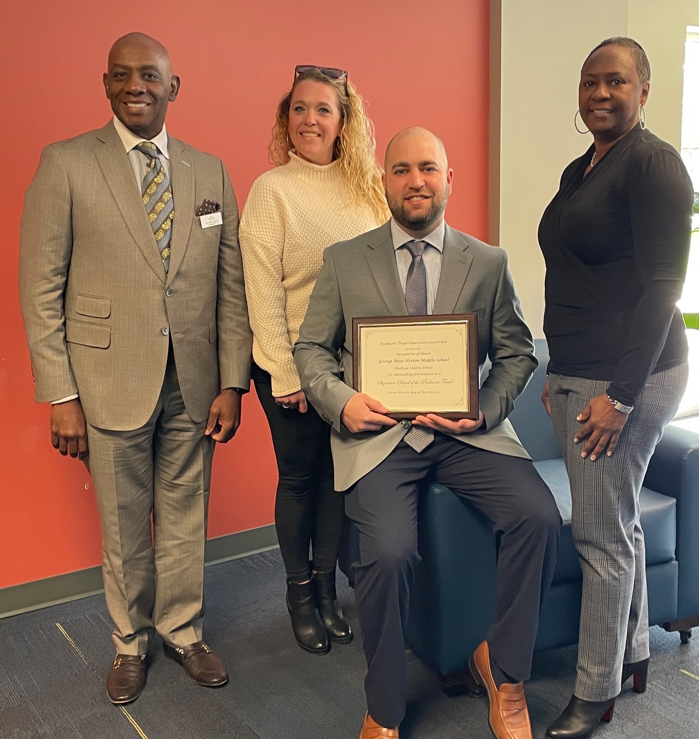 George Moses Horton Middle School was named a Signature School by the Piedmont Triad Education Consortium. From left to right: Dr. Anthony Jackson; Colleen D'Angelo, 5th grade teacher; Bradyn Robinson, principal; Nina Eaddy, 7th grade teacher.